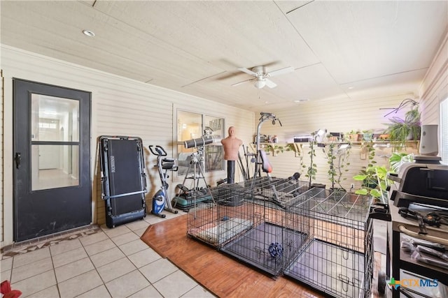 gym with tile patterned floors and ceiling fan