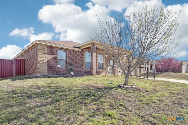 ranch-style house featuring stone siding, brick siding, and a front lawn