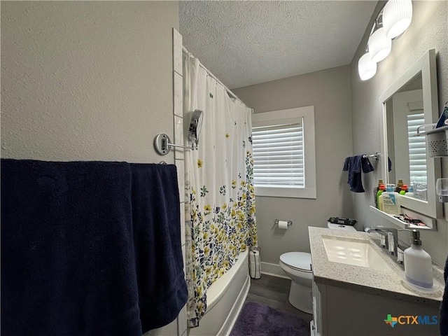 1308 E Park Ave, Victoria, TX 77901 - bathroom featuring a textured ceiling, toilet, vanity, wood finished floors, and shower / tub combo with curtain