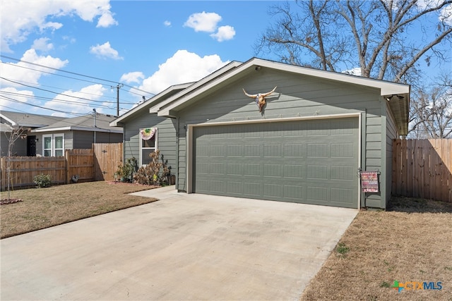 view of front of property with a garage and fence