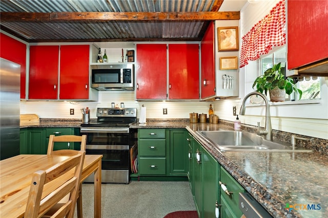 kitchen featuring stainless steel appliances, beamed ceiling, and sink