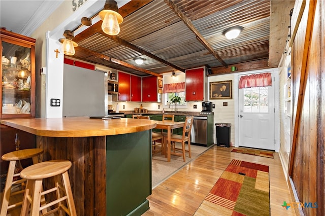 kitchen featuring dishwasher, light hardwood / wood-style floors, and crown molding