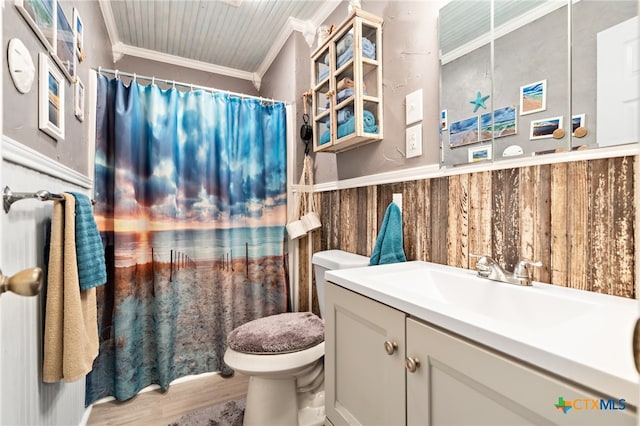 bathroom featuring toilet, hardwood / wood-style floors, wood walls, vanity, and crown molding