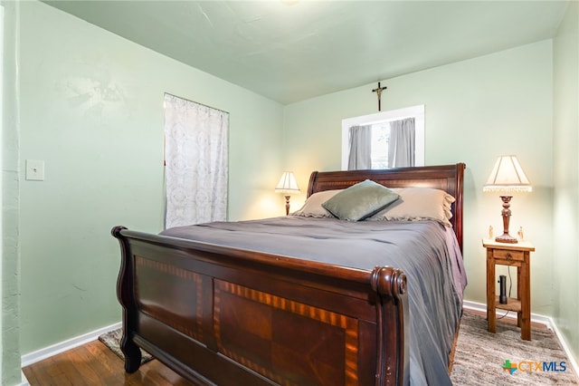 bedroom with hardwood / wood-style flooring