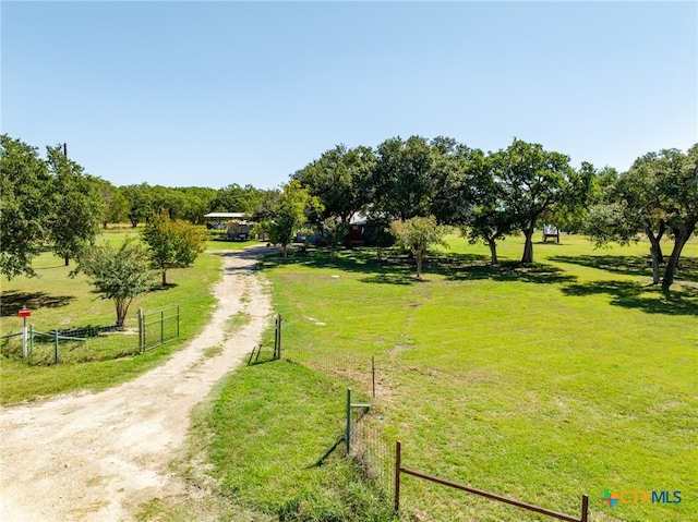 surrounding community featuring a lawn and a rural view