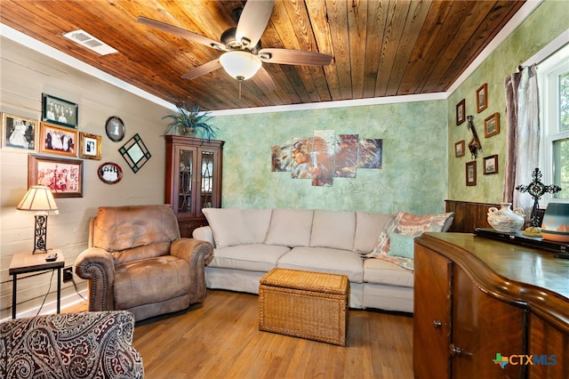 living room featuring ceiling fan, wood-type flooring, wood ceiling, and crown molding