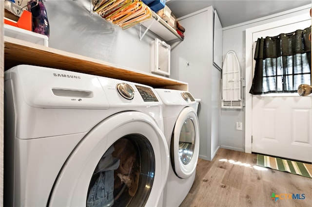 washroom with light hardwood / wood-style flooring and independent washer and dryer