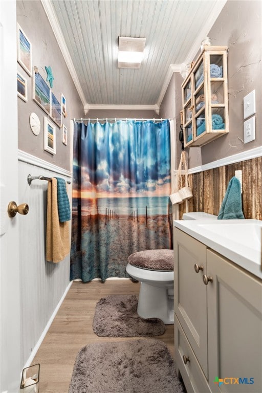 bathroom featuring toilet, wood walls, wood-type flooring, and crown molding