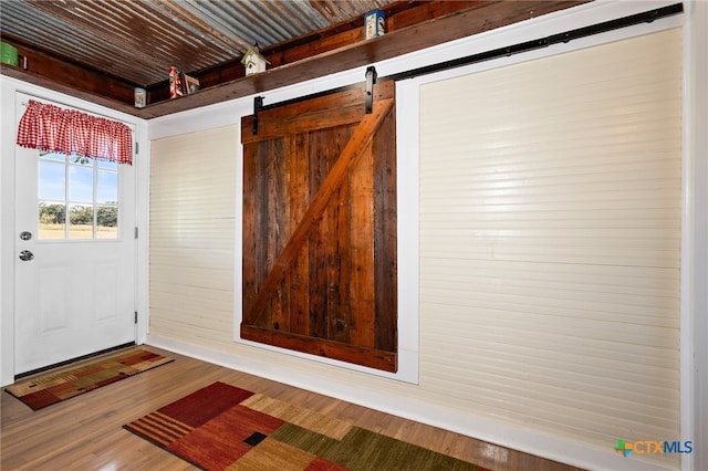 interior space featuring a barn door and wood-type flooring