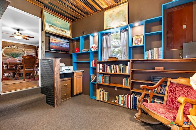 interior space featuring ornamental molding, carpet floors, ceiling fan, and wooden ceiling