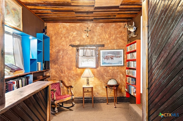 living area with wood ceiling and carpet