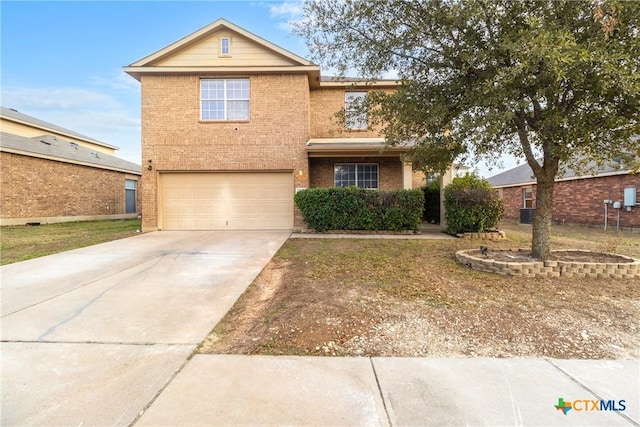 traditional-style home featuring an attached garage, concrete driveway, and brick siding