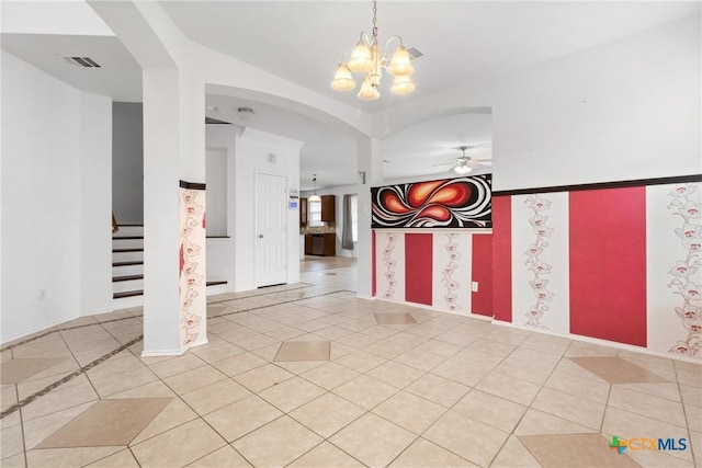 entrance foyer with light tile patterned floors, stairway, ceiling fan with notable chandelier, and visible vents