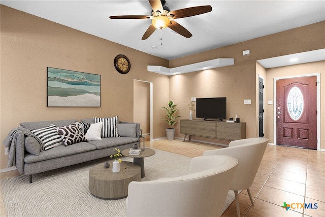 tiled living room with ceiling fan