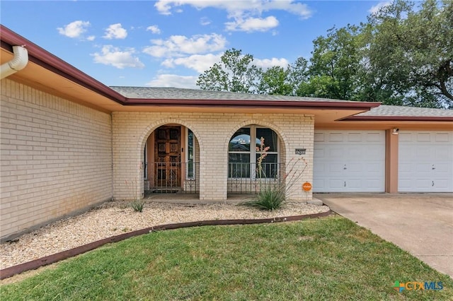 707 Dianne Dr, Copperas Cove, TX 76522 - doorway to property featuring brick siding, an attached garage, driveway, and a shingled roof