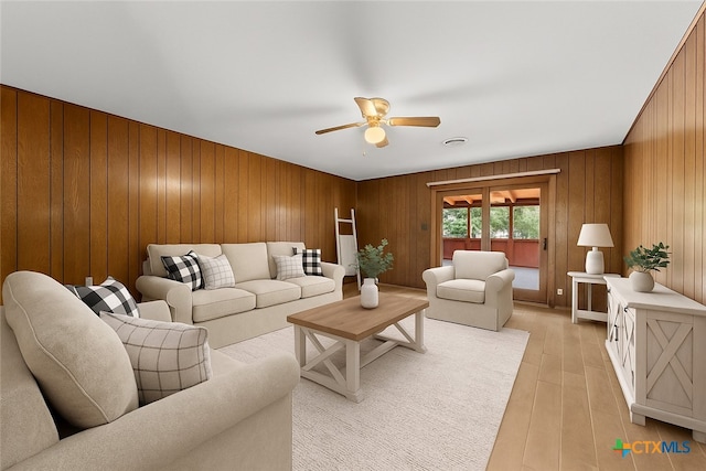 707 Dianne Dr, Copperas Cove, TX 76522 - living room featuring ceiling fan, wooden walls, and light wood-style flooring