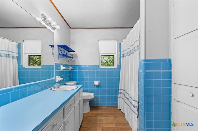 707 Dianne Dr, Copperas Cove, TX 76522 - full bath featuring tile walls, vanity, a wainscoted wall, wood finished floors, and toilet