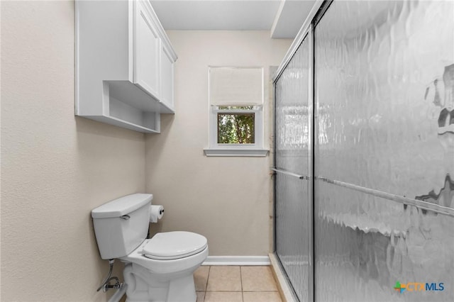 707 Dianne Dr, Copperas Cove, TX 76522 - full bathroom with a stall shower, toilet, tile patterned flooring, and baseboards