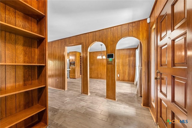 707 Dianne Dr, Copperas Cove, TX 76522 - entrance foyer featuring arched walkways, wood walls, and wood finished floors