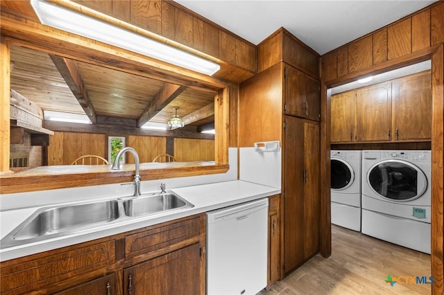 707 Dianne Dr, Copperas Cove, TX 76522 - kitchen featuring white dishwasher, independent washer and dryer, a sink, light countertops, and light wood-type flooring