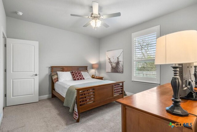 488 Creekside Dr, Belton, TX 76513 - bedroom with light colored carpet, a ceiling fan, and baseboards