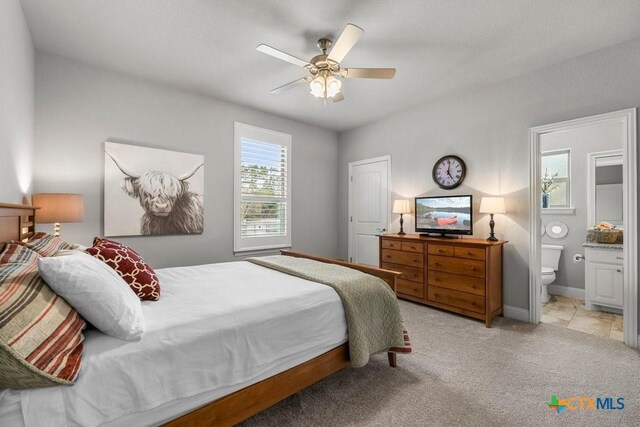488 Creekside Dr, Belton, TX 76513 - bedroom featuring light colored carpet, connected bathroom, a ceiling fan, and baseboards