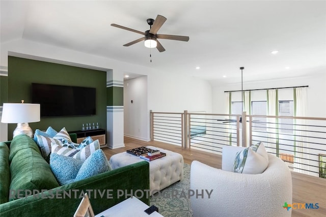 living room with a ceiling fan, wood finished floors, recessed lighting, and baseboards