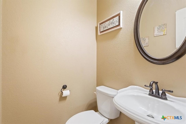 bathroom with sink and toilet