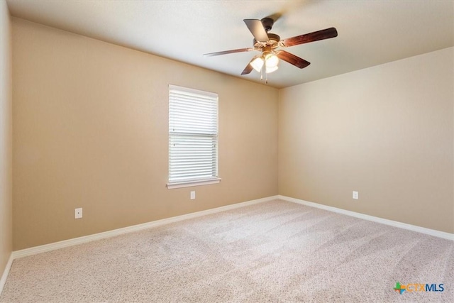 carpeted spare room with ceiling fan