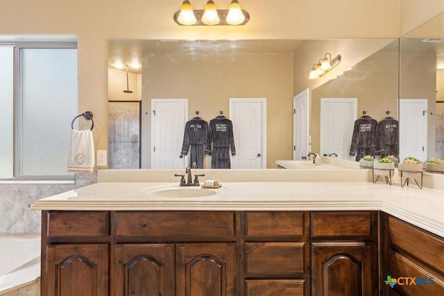 bathroom featuring a tub and vanity