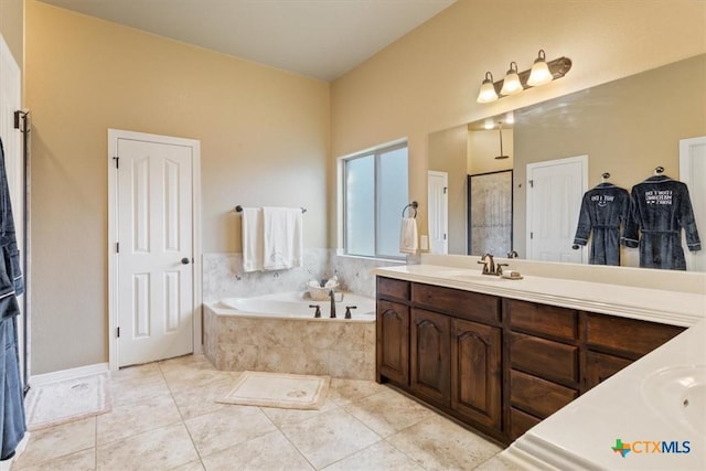 bathroom featuring tile patterned floors, vanity, and tiled tub