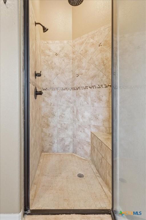 bathroom with a shower with door