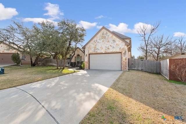 view of front of home featuring a garage and a front lawn