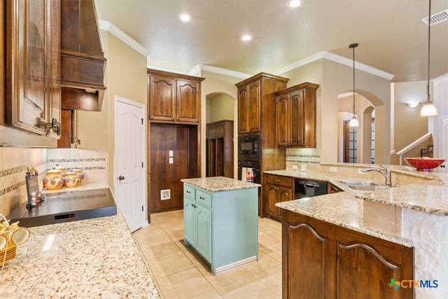 kitchen with light stone countertops, black appliances, decorative light fixtures, backsplash, and sink