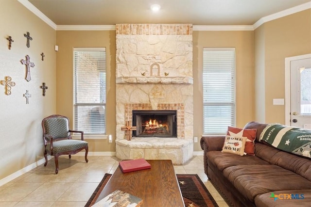 living room with a fireplace, ornamental molding, and light tile patterned flooring