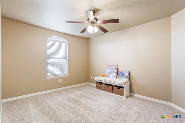 spare room featuring ceiling fan and carpet