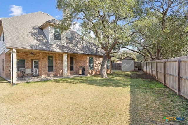 exterior space featuring a front lawn, a patio, and a storage shed