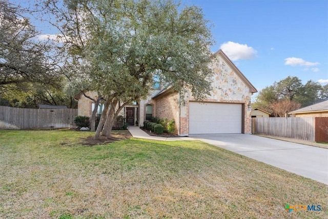 view of front of home with a garage and a front lawn