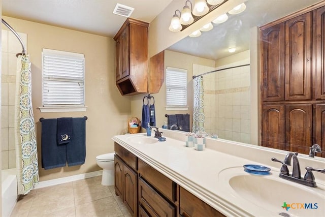 full bathroom with shower / tub combo with curtain, toilet, vanity, and tile patterned flooring