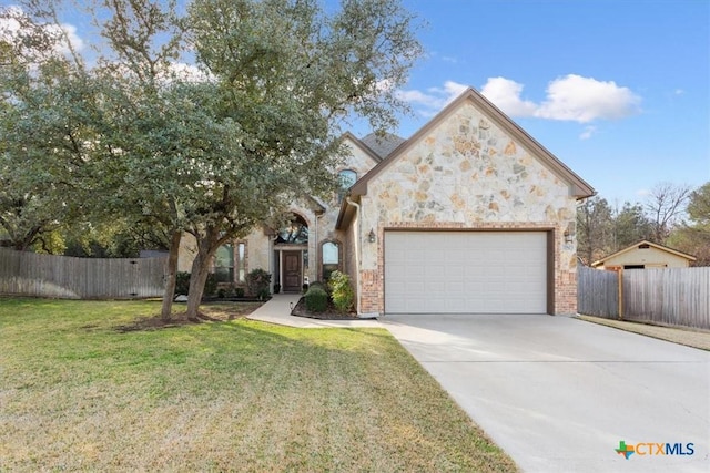 view of front of house featuring a front lawn and a garage