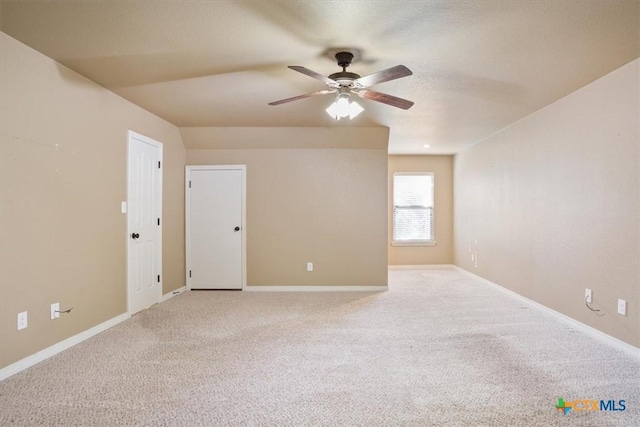 empty room featuring a textured ceiling, carpet flooring, and ceiling fan