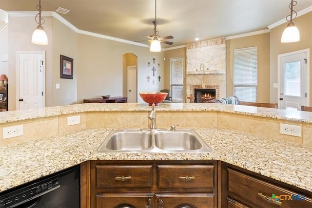 kitchen with sink, ornamental molding, a fireplace, and dishwasher