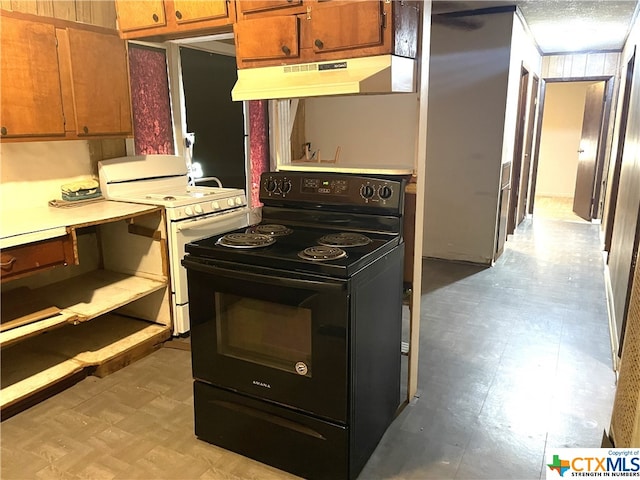 kitchen with black electric range and white range with gas stovetop