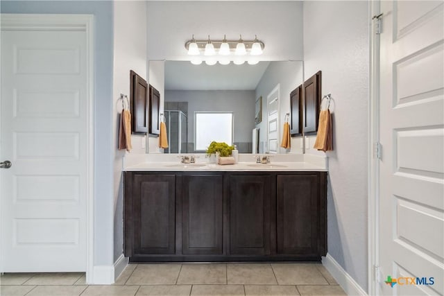 1433 Kamryn Way, New Braunfels, TX 78130 - full bathroom with tile patterned flooring, double vanity, baseboards, and a shower