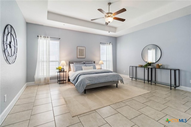 1433 Kamryn Way, New Braunfels, TX 78130 - bedroom with light tile patterned floors, a tray ceiling, baseboards, and a ceiling fan