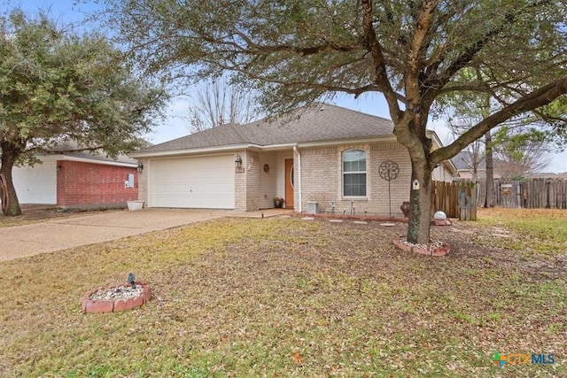 single story home featuring a garage and a front yard