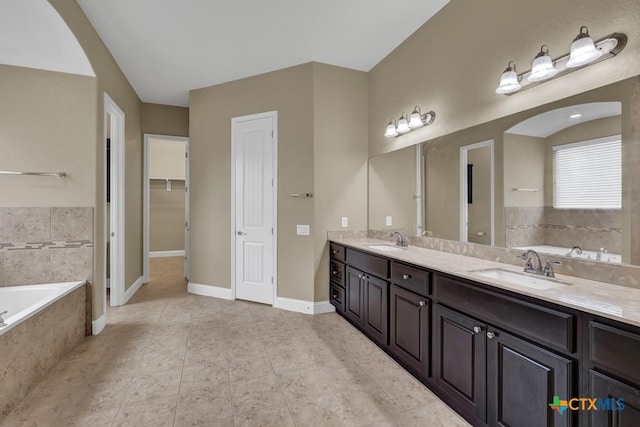 2194 Ranch Loop Dr, New Braunfels, TX 78132 - full bathroom featuring a bath, double vanity, and tile patterned floors