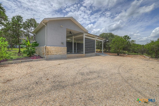 2194 Ranch Loop Dr, New Braunfels, TX 78132 - view of side of property with stucco siding, stone siding, and a ceiling fan