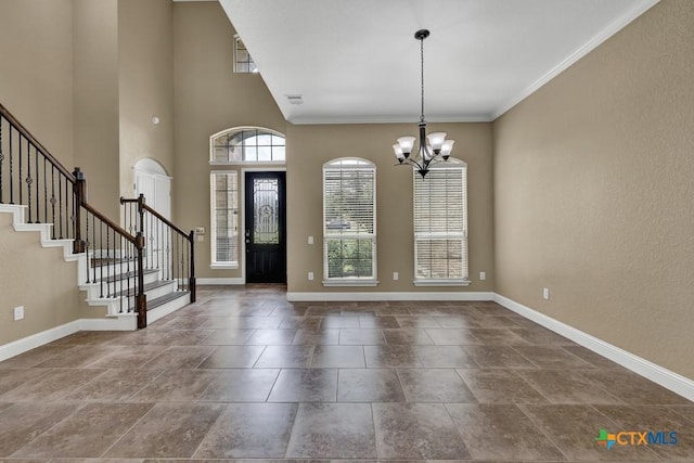 2194 Ranch Loop Dr, New Braunfels, TX 78132 - foyer entrance featuring stairway, a chandelier, crown molding, and dark stone finish floors