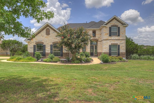 2194 Ranch Loop Dr, New Braunfels, TX 78132 - french country style house featuring stone siding and a front yard